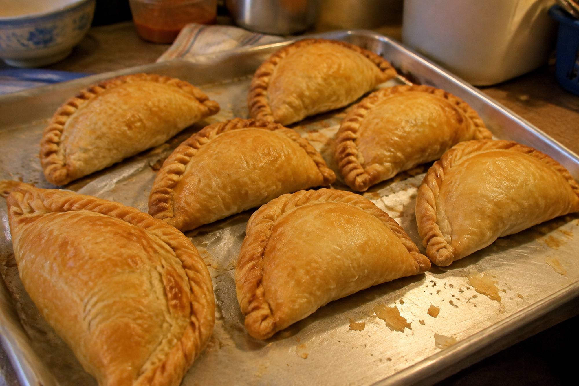 A tray of golden puff pastry curry puffs